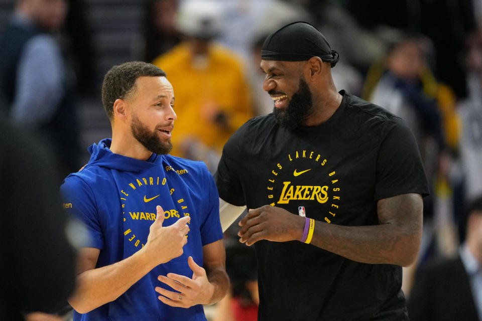 Dec 25, 2024; San Francisco, California, USA; Golden State Warriors guard Stephen Curry (left) and Los Angeles Lakers forward LeBron James (right) talk before the game at Chase Center. Mandatory Credit: Darren Yamashita-Imagn Images