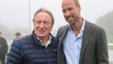Football legend Neil Warnock poses for a photo with ‘fan’ Prince William after royal helped stranded local football club