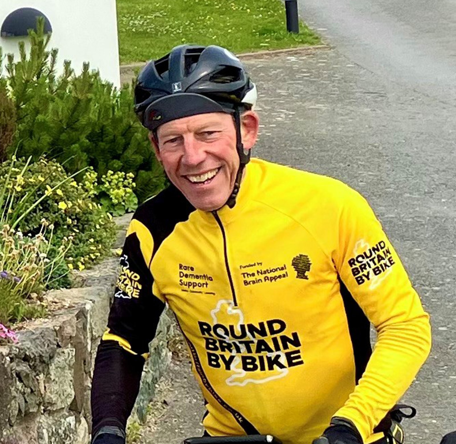 Man dressed in yellow lycra wearing helmet