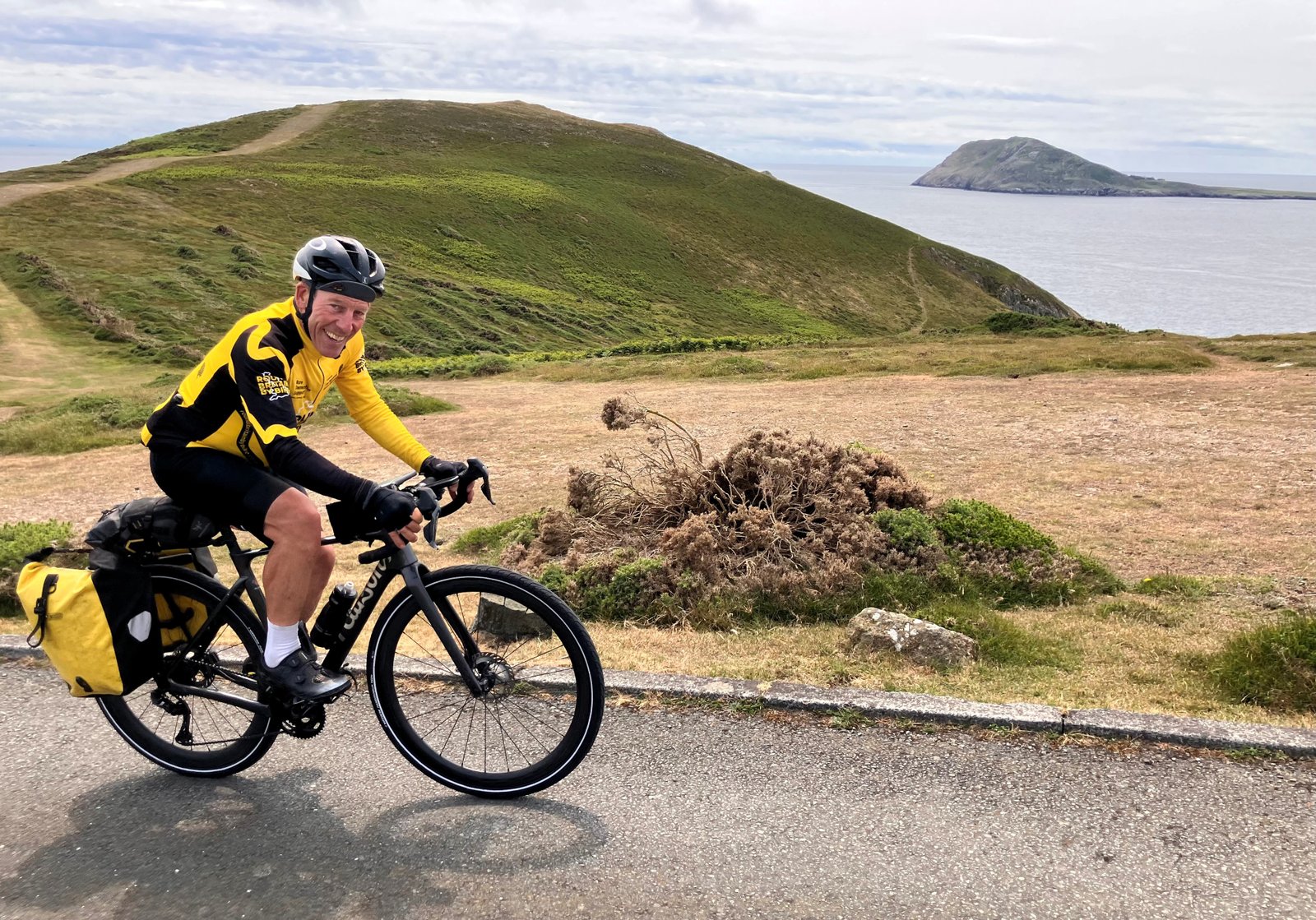 Man cycles next to the coast