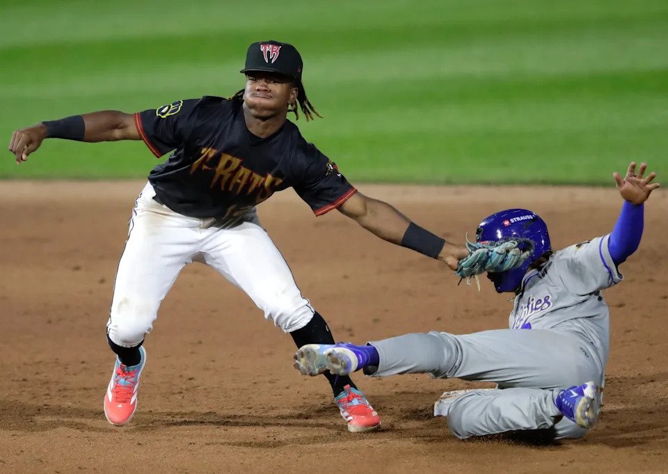Wisconsin Timber Rattlers shortstop Jesus Made (12) tags out the Quad Cities River Bandits' Erick Torres at second base during a game at Fox Cities Stadium in Grand Chute, Wisconsin, on Aug. 27, 2025.