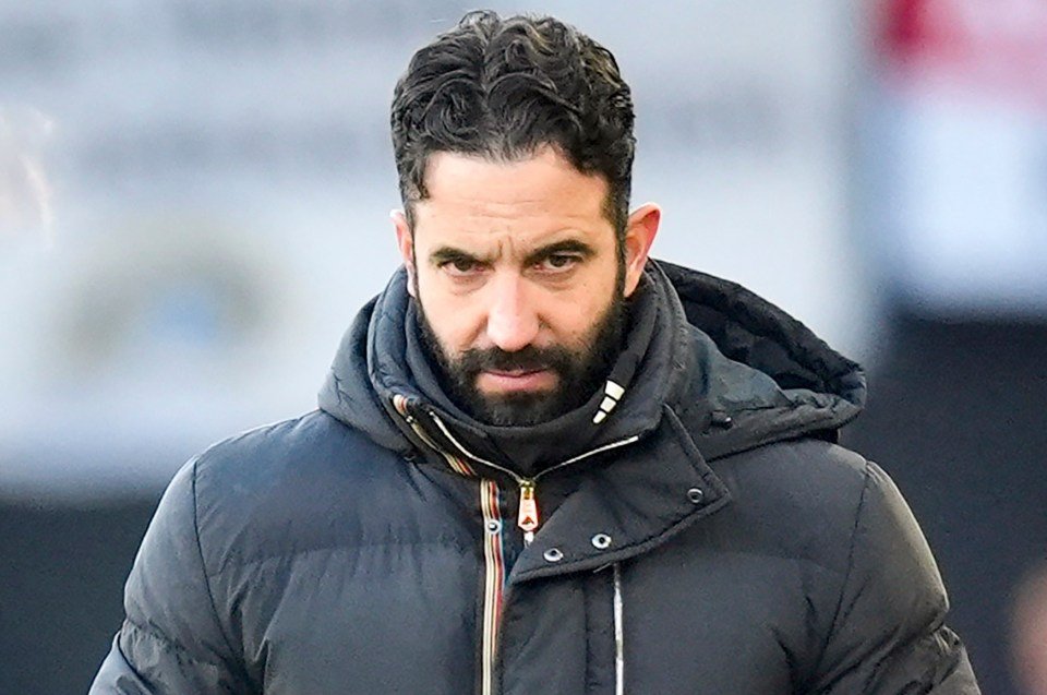 Manchester United manager Ruben Amorim wearing a dark winter coat and gloves.