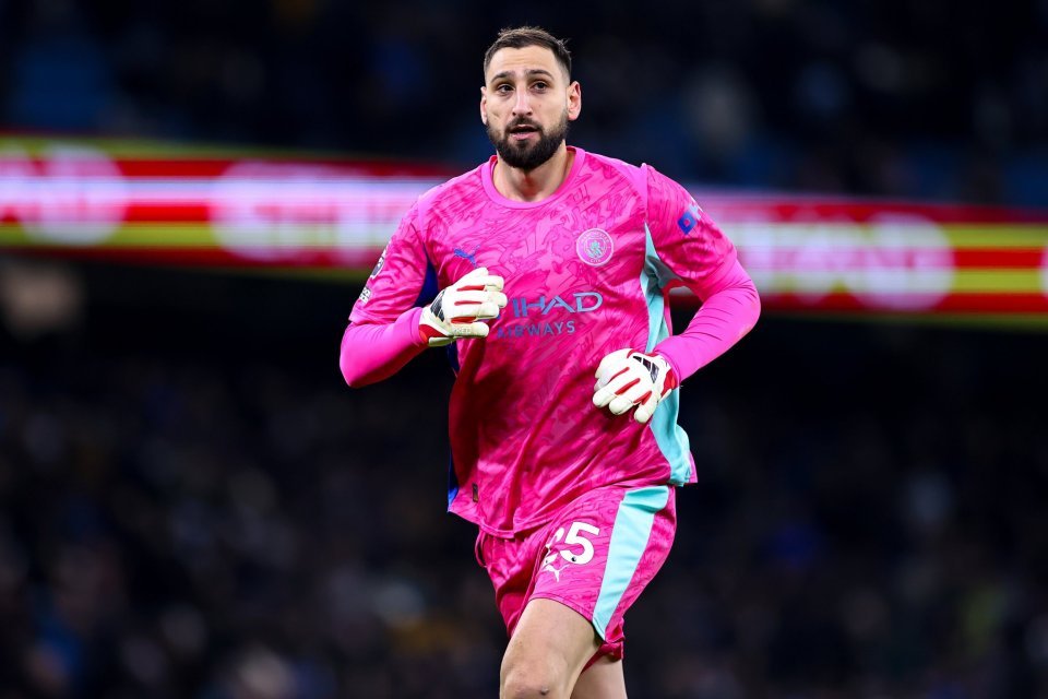 Manchester City player in a pink and light blue uniform during a Premier League match.