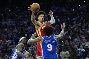 Johnson and McCollum power Hawks past the 76ers 117-117 as Atlanta snaps 3-game skid
