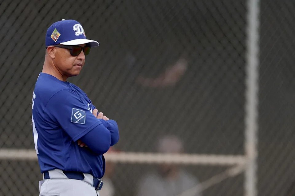 Dodgers manager Dave Roberts watches players work out during spring training at Camelback Ranch in Arizona Monday.