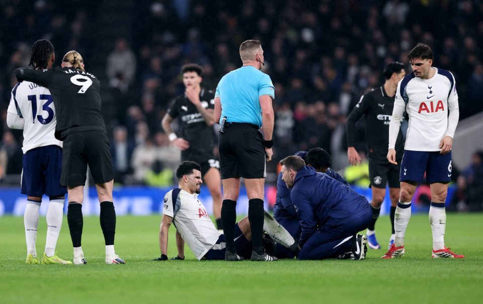 Tottenham Hotspur player Richarlison receiving medical attention on the field during a match against Manchester City.