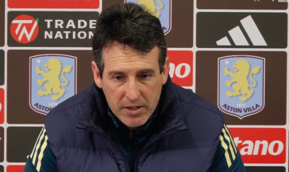 Unai Emery speaking at a press conference with Aston Villa and sponsor logos in the background.