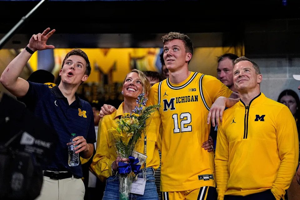 Michigan head coach Dusty May, his wife Anna May, and youngest son, Eli (left) join guard Charlie May (12) during senior day celebration at Crisler Center in Ann Arbor on Sunday, March 8, 2026.