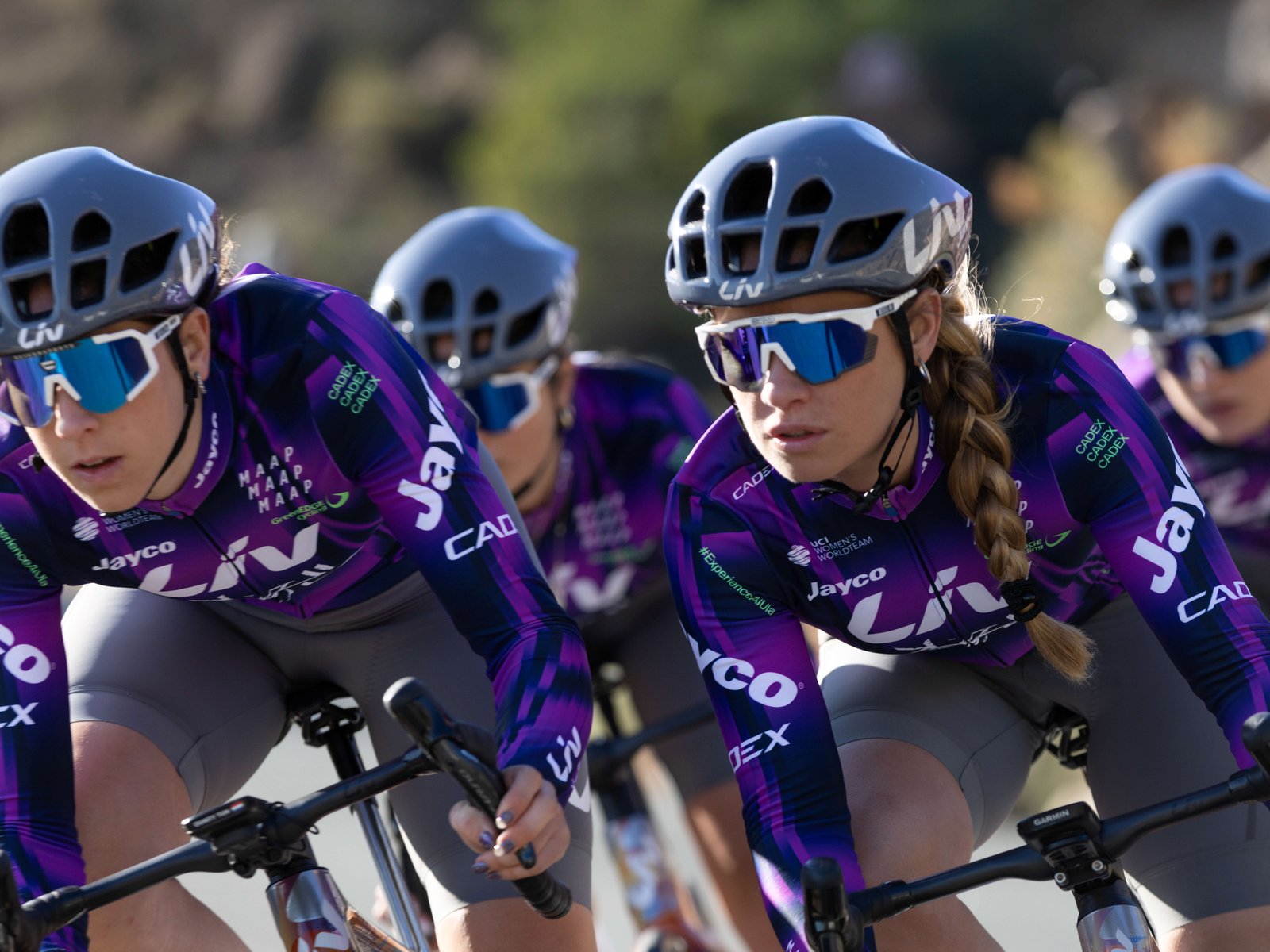 Four cyclists turn a corner