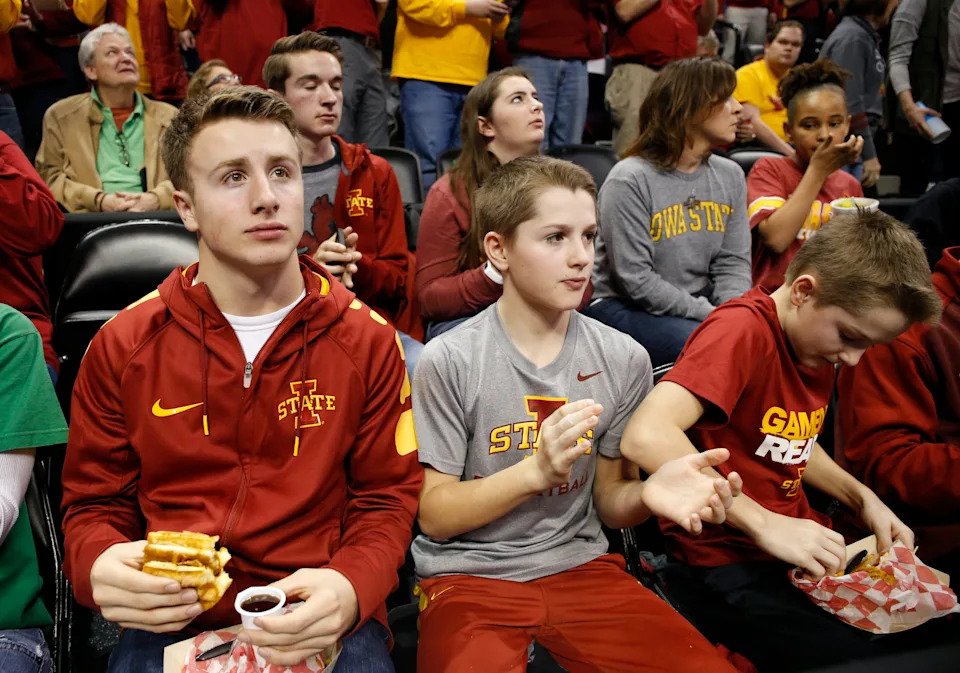 Jack Hoiberg, 17 (from left) and twins Sam and Charlie Hoiberg, 12, cheer on Iowa State from behind the players bench Thursday, March 17, 2016, during their first round game at the NCAA men's basketball tournament at the Pepsi Center in Denver.