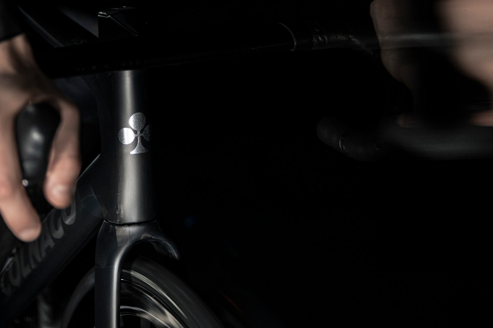 shadowy shots of a black Colnago bike on a black background