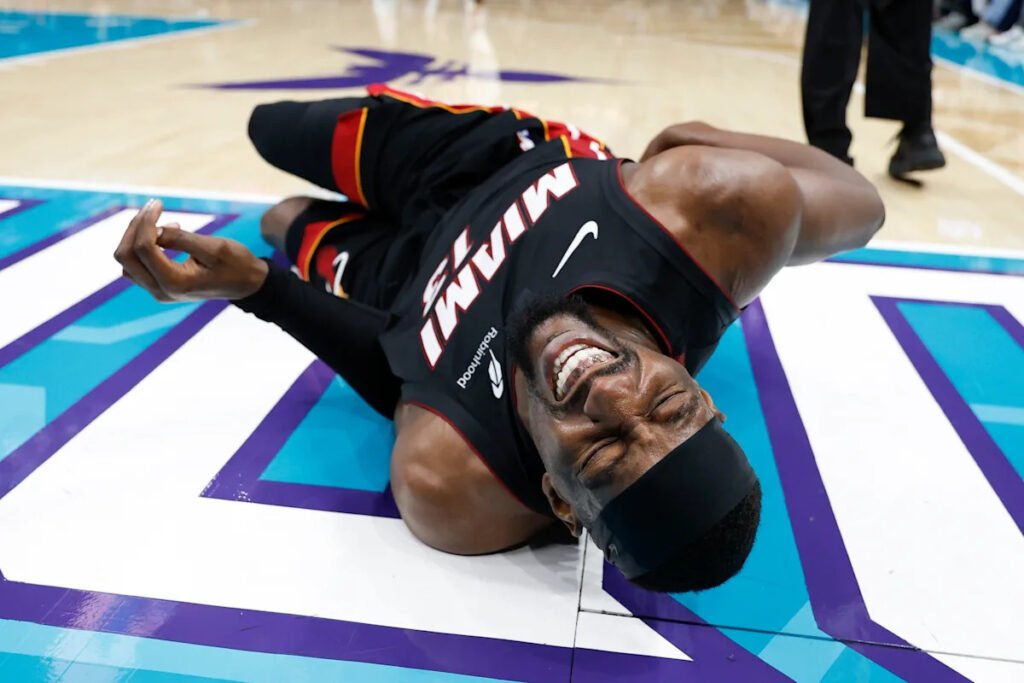 Heat’s Bam Adebayo taken to locker room after Hornets’ LaMelo Ball trips him, leading to hard fall