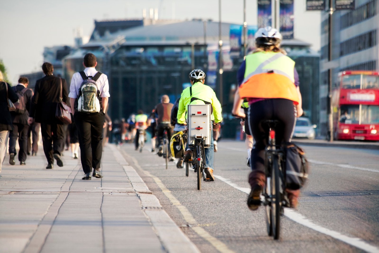Commuters in high-viz riding along a cycle lane