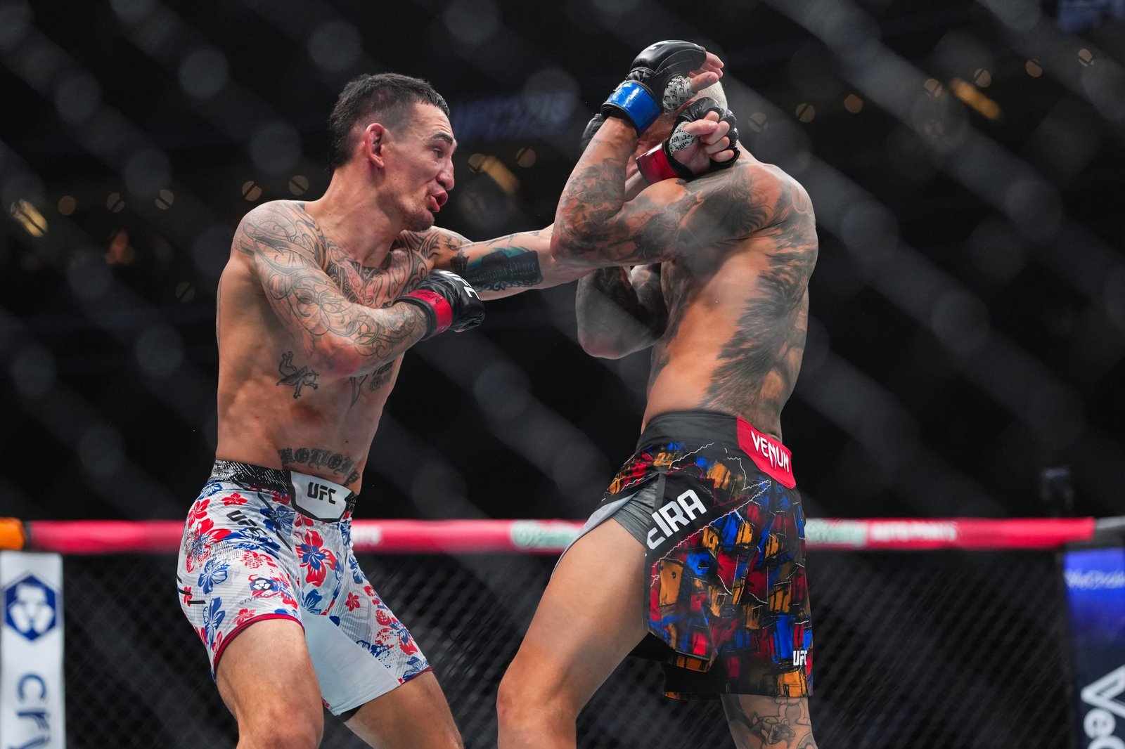 LAS VEGAS, NEVADA - MARCH 07: (L-R) Max Holloway strikes Charles Oliveira of Brazil in the BMF Championship fight during the UFC 326 event at T-Mobile Arena on March 07, 2026 in Las Vegas, Nevada. (Photo by Cooper Neill/Zuffa LLC)