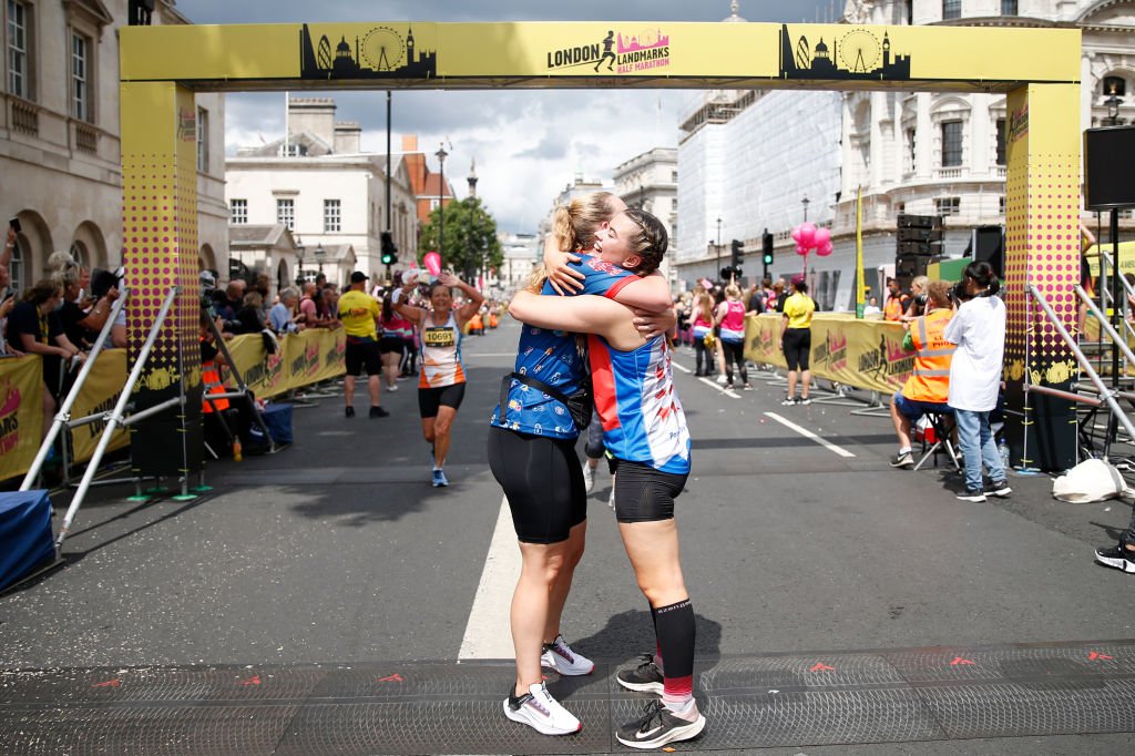 Two women hug after running the 2021 London Marathon