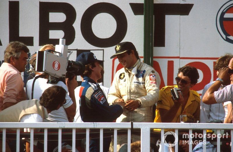 Podium: race winner Elio de Angelis, Lotus Ford congratulated by Keke Rosberg, Williams, 2nd position